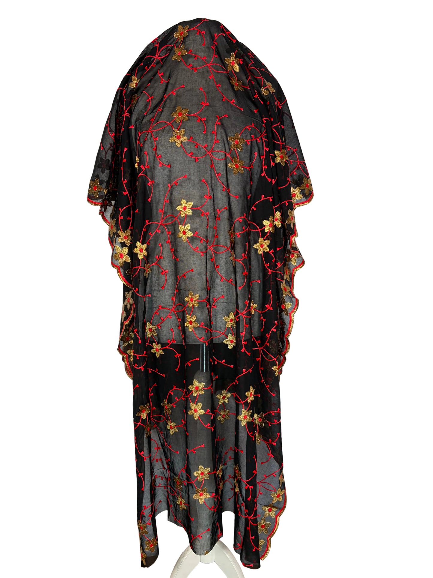 Black fabric with red and gold floral patterns on a white background