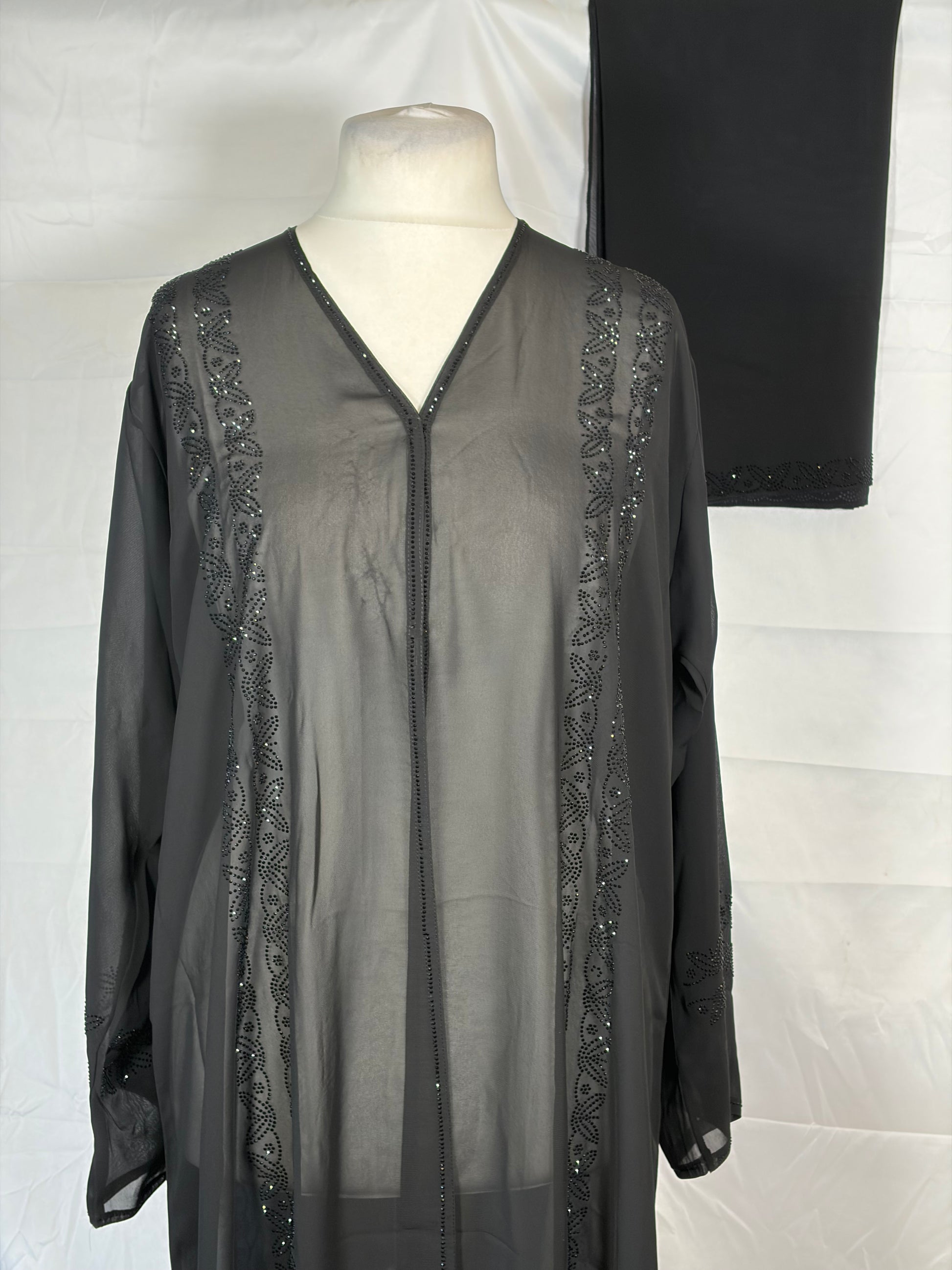 Black open abaya with lace details on a white background
