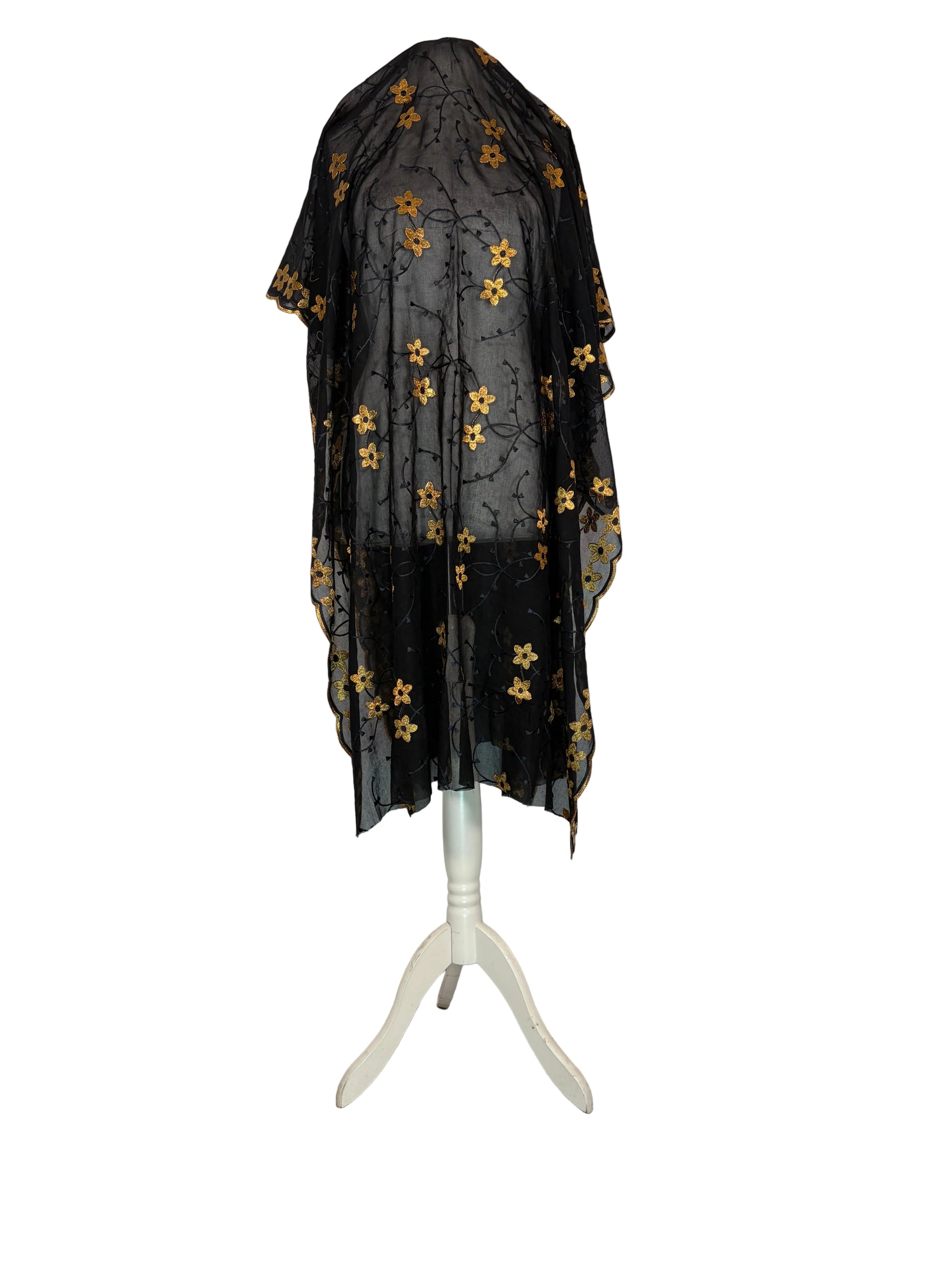 Black Garbasaar fabric with gold patterns on a white surface