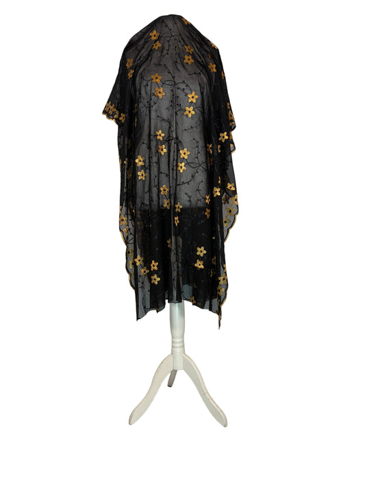Black Garbasaar fabric with gold patterns on a white surface