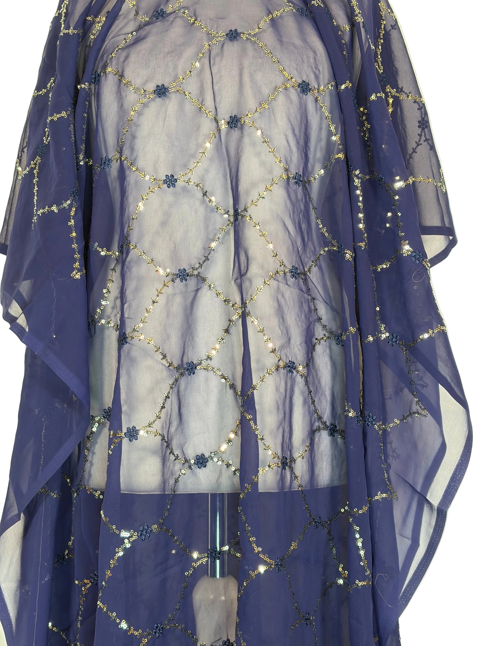Blue fabric with silver embellishments on a beige background