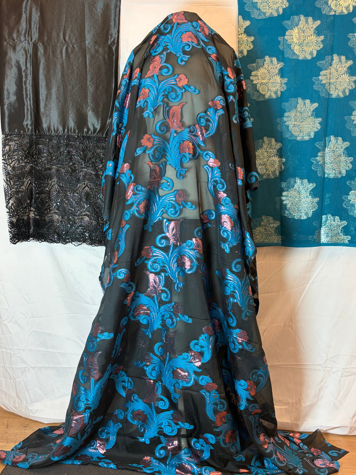 Somali fransawi Dirac fabric with blue floral patterns on a white surface