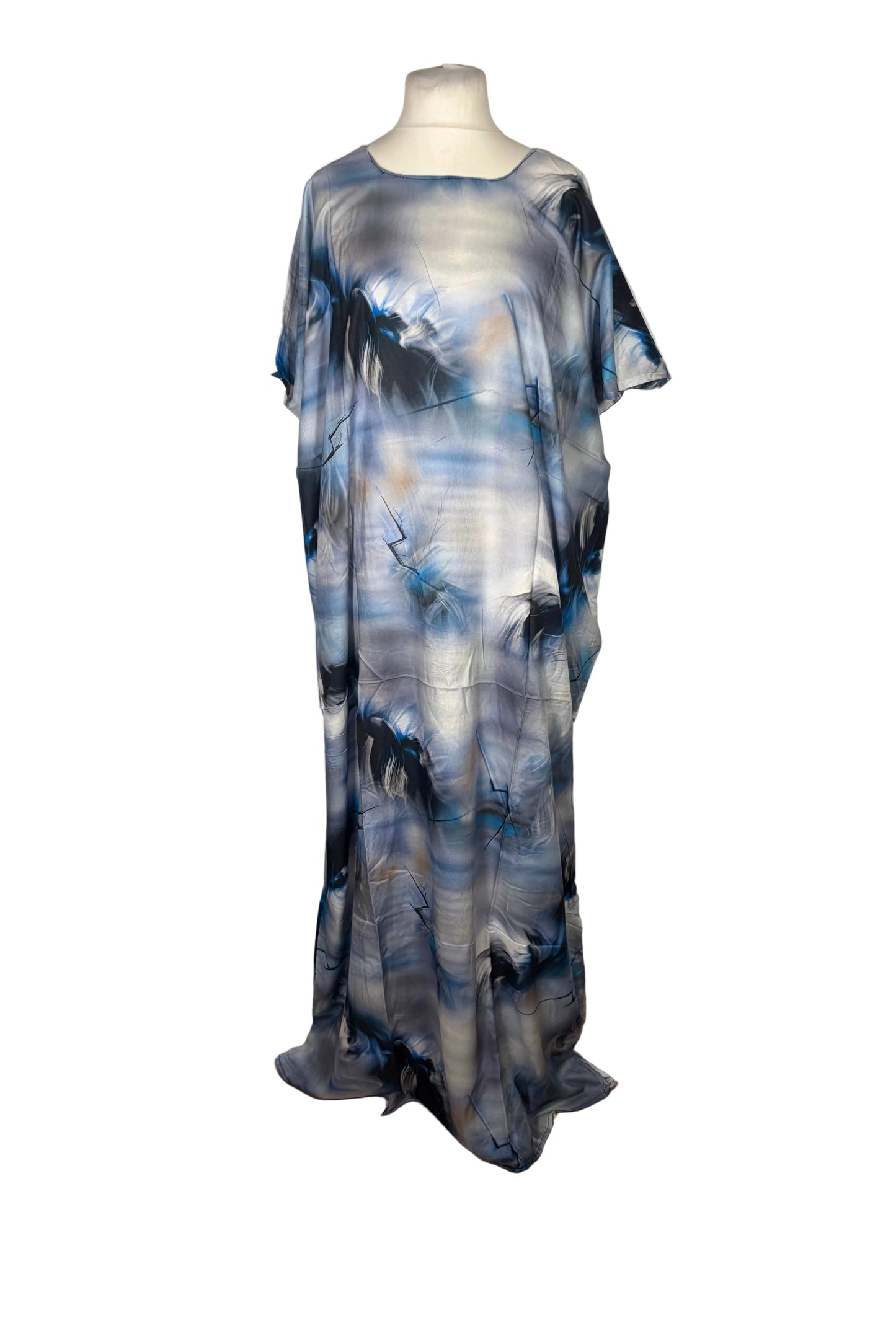 Blue and gray abstract patterned Somali Baati dress on a mannequin against a white curtain.