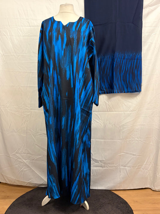 Blue and black patterned dress on a mannequin against a white background