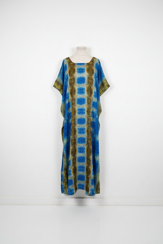 Long Somali baati dress with blue and green pattern on a mannequin against a white background