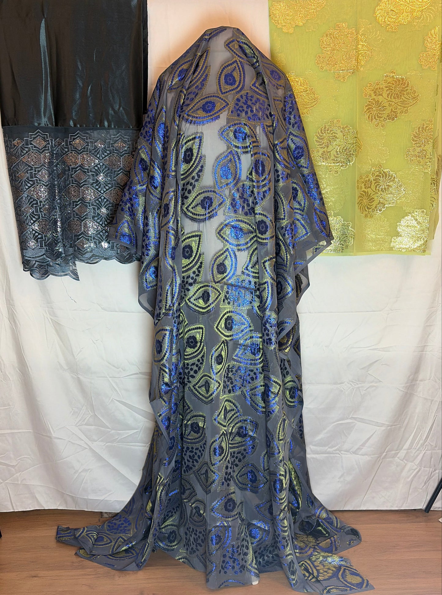 Blue patterned Somali Dirac fabric on a white surface with a wooden background