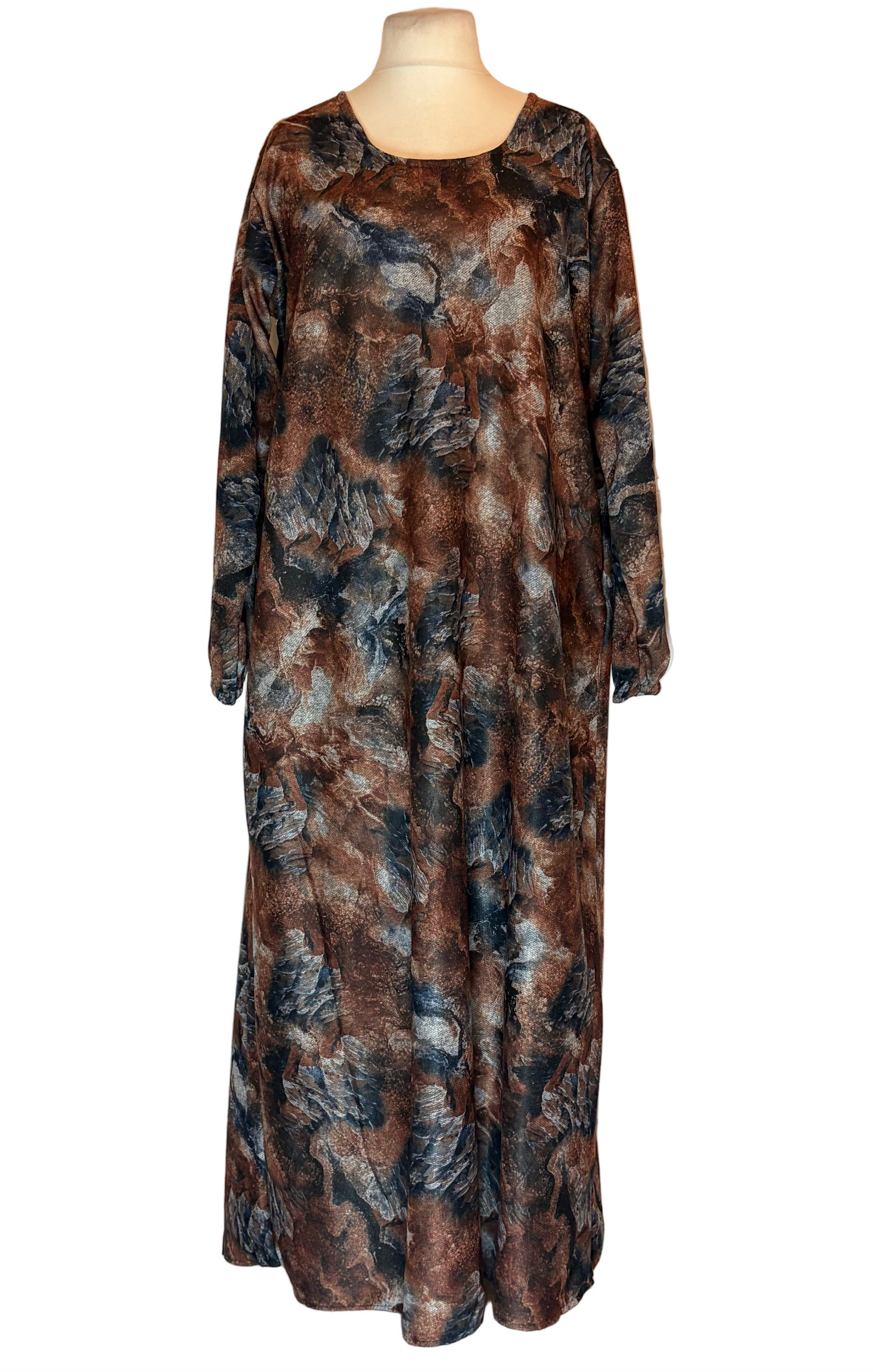 Long, patterned dress on a mannequin against a white background
