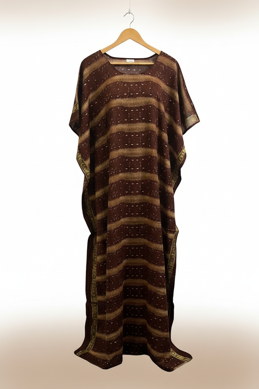 Brown patterned dress on a hanger against a plain background