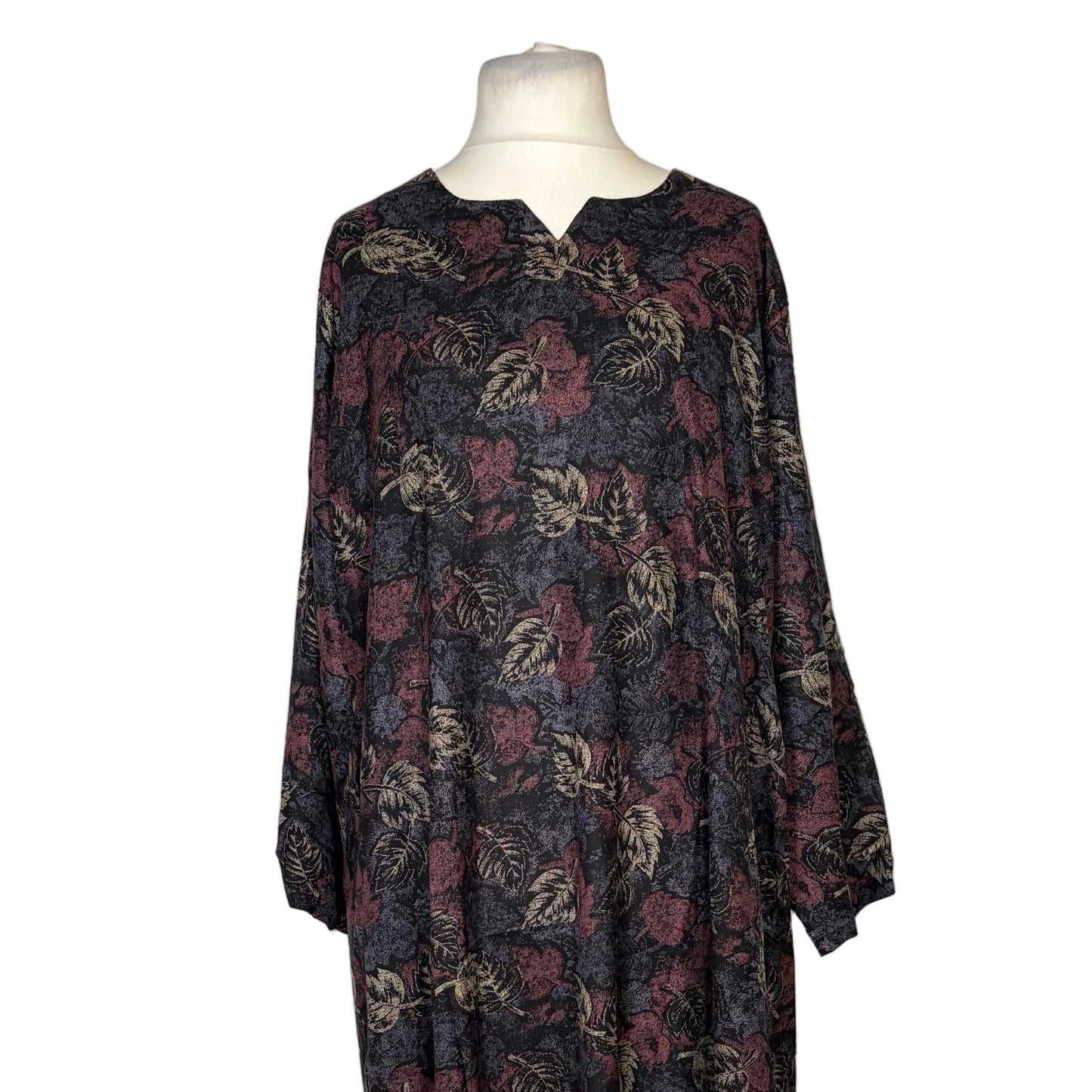 Floral patterned dress on a mannequin against a white background