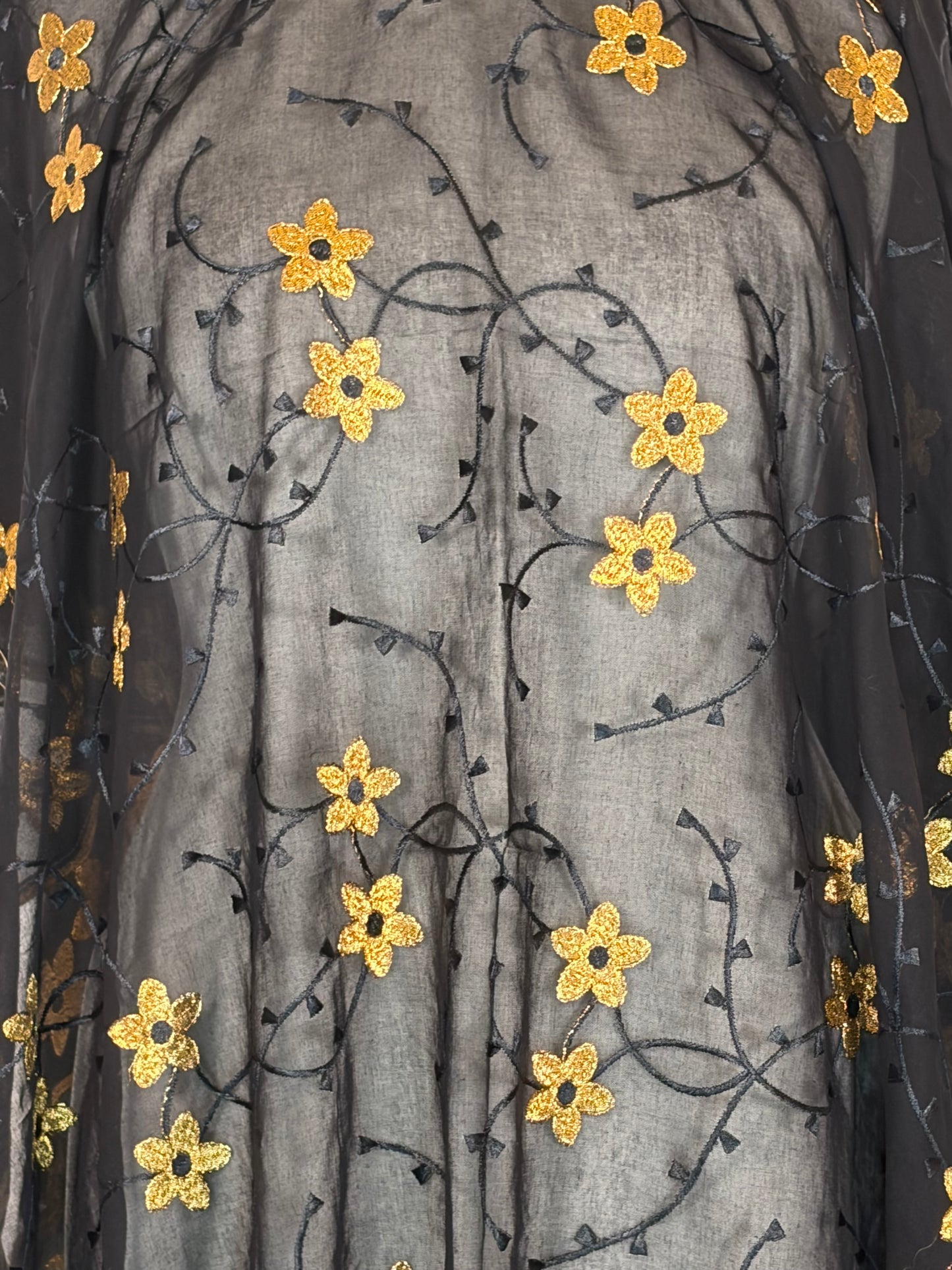 Decorative fabric with gold floral patterns on a gray background