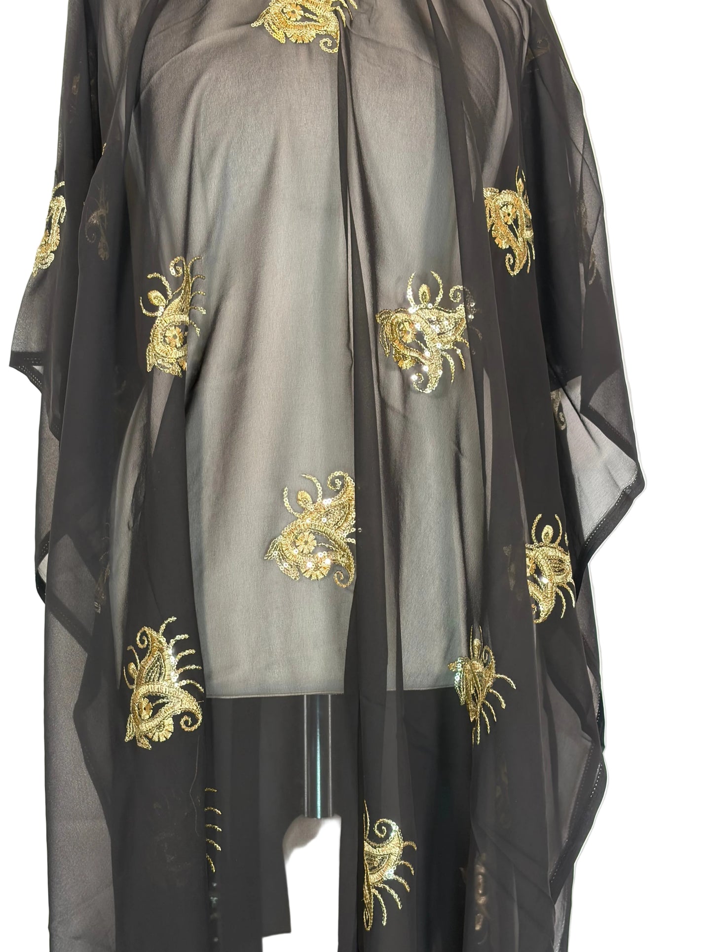 Black fabric with gold embroidery patterns on a white background