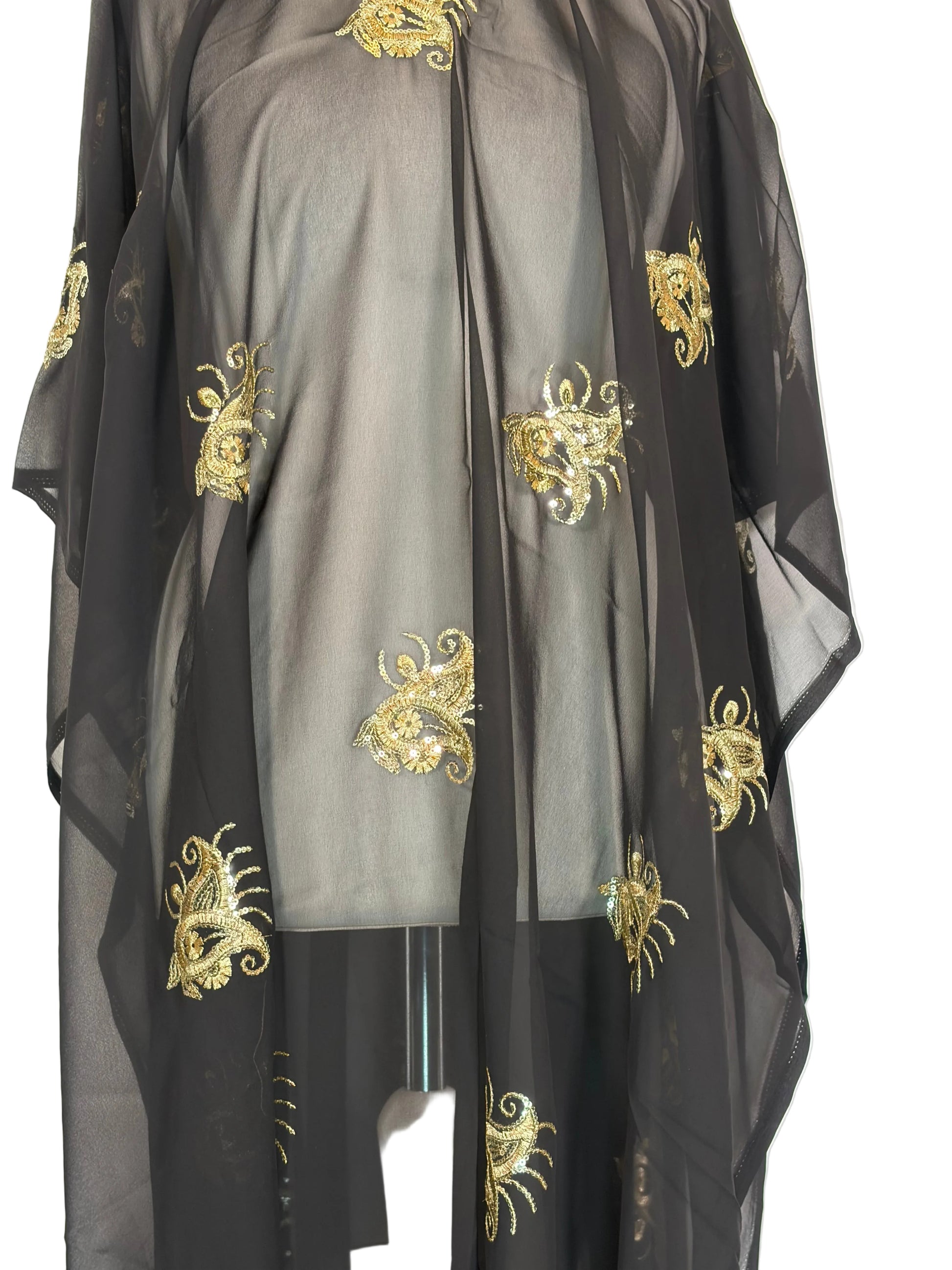 Black fabric with gold embroidery patterns on a white background