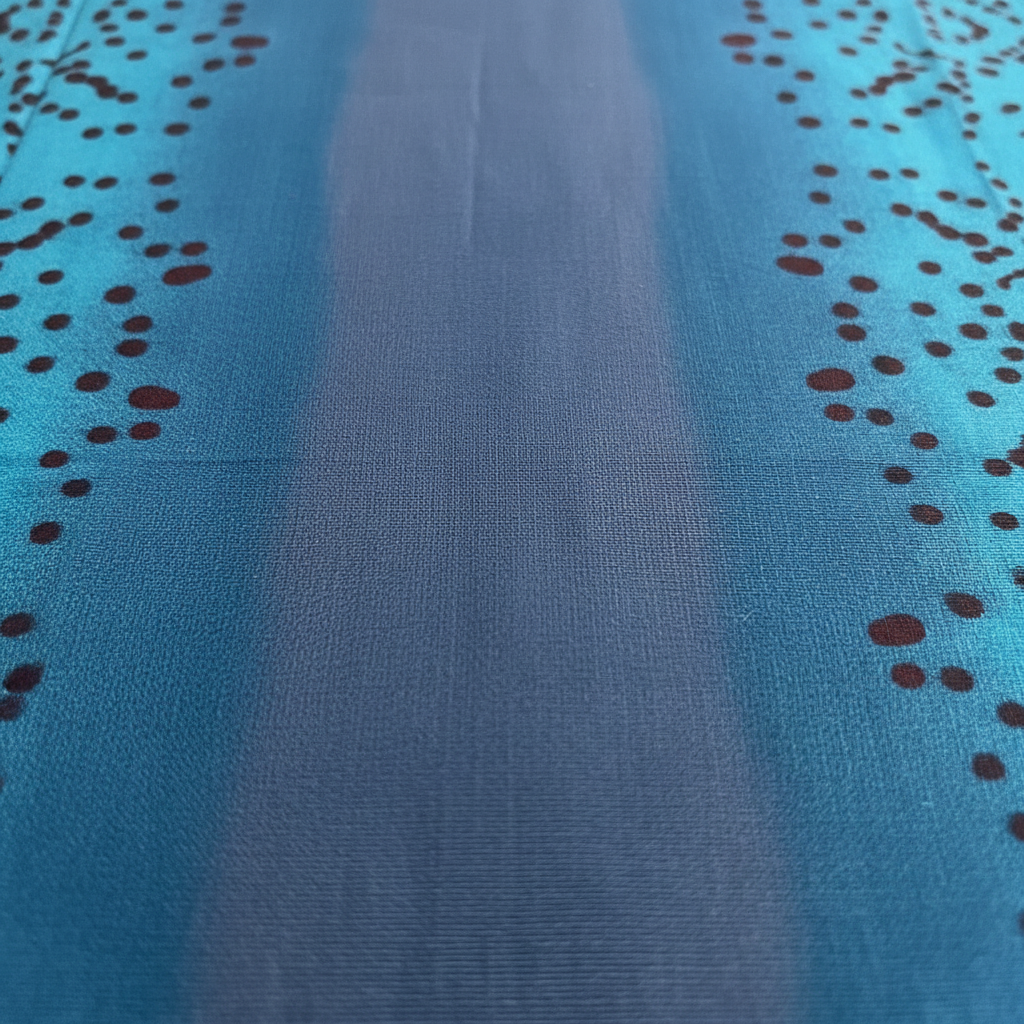 Close-up of blue Baati fabric with black dot pattern
