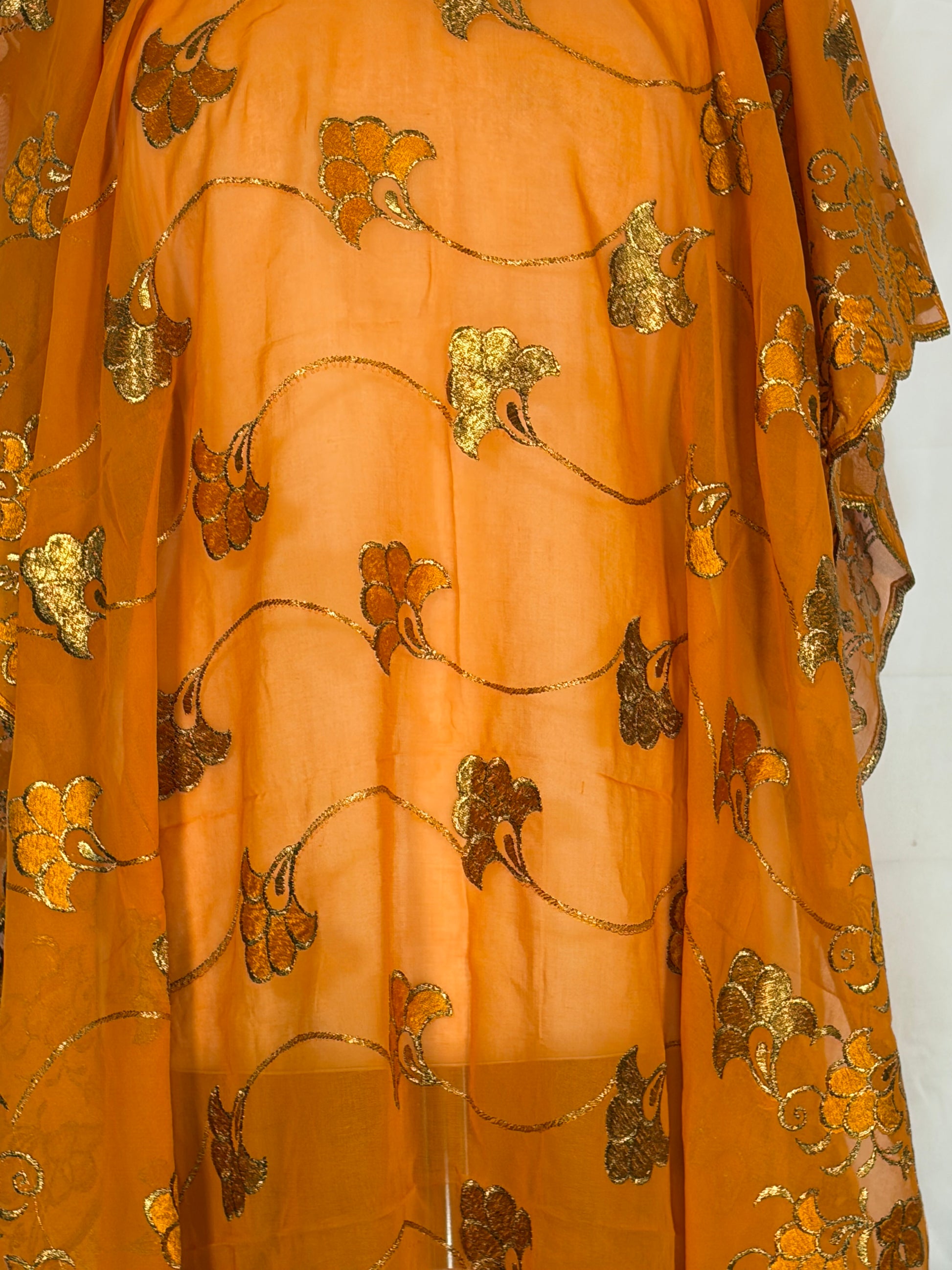 Gold fabric with floral patterns on a white background