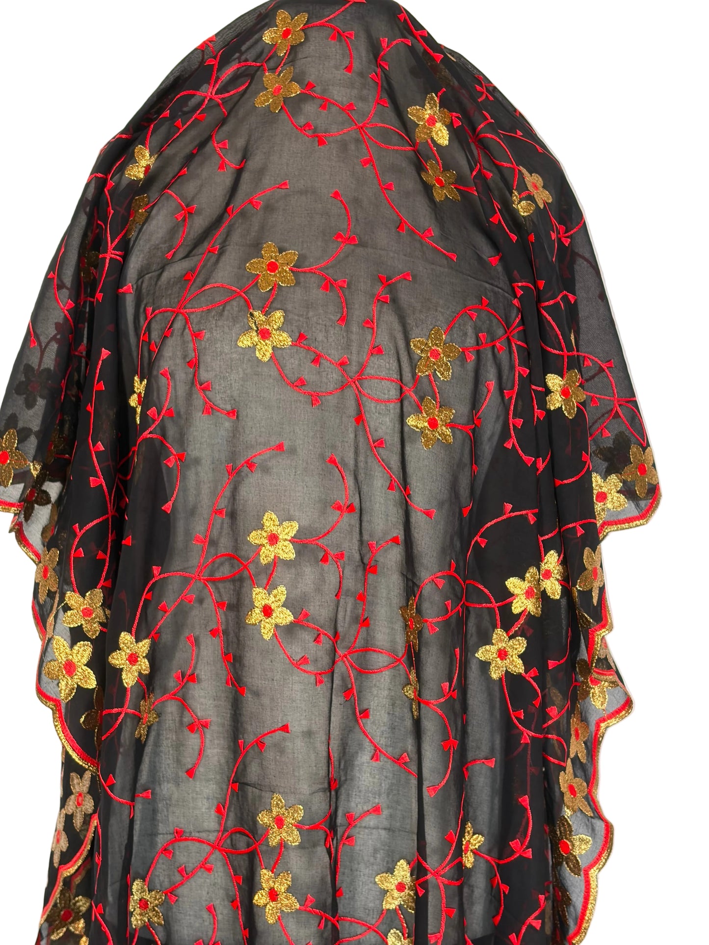 Black fabric with red and gold floral embroidery on a white background