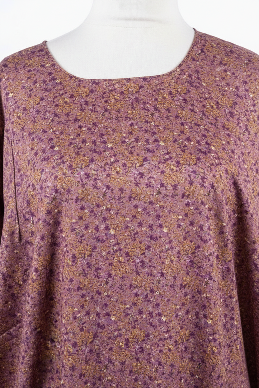 Purple floral patterned top on a mannequin with a white background