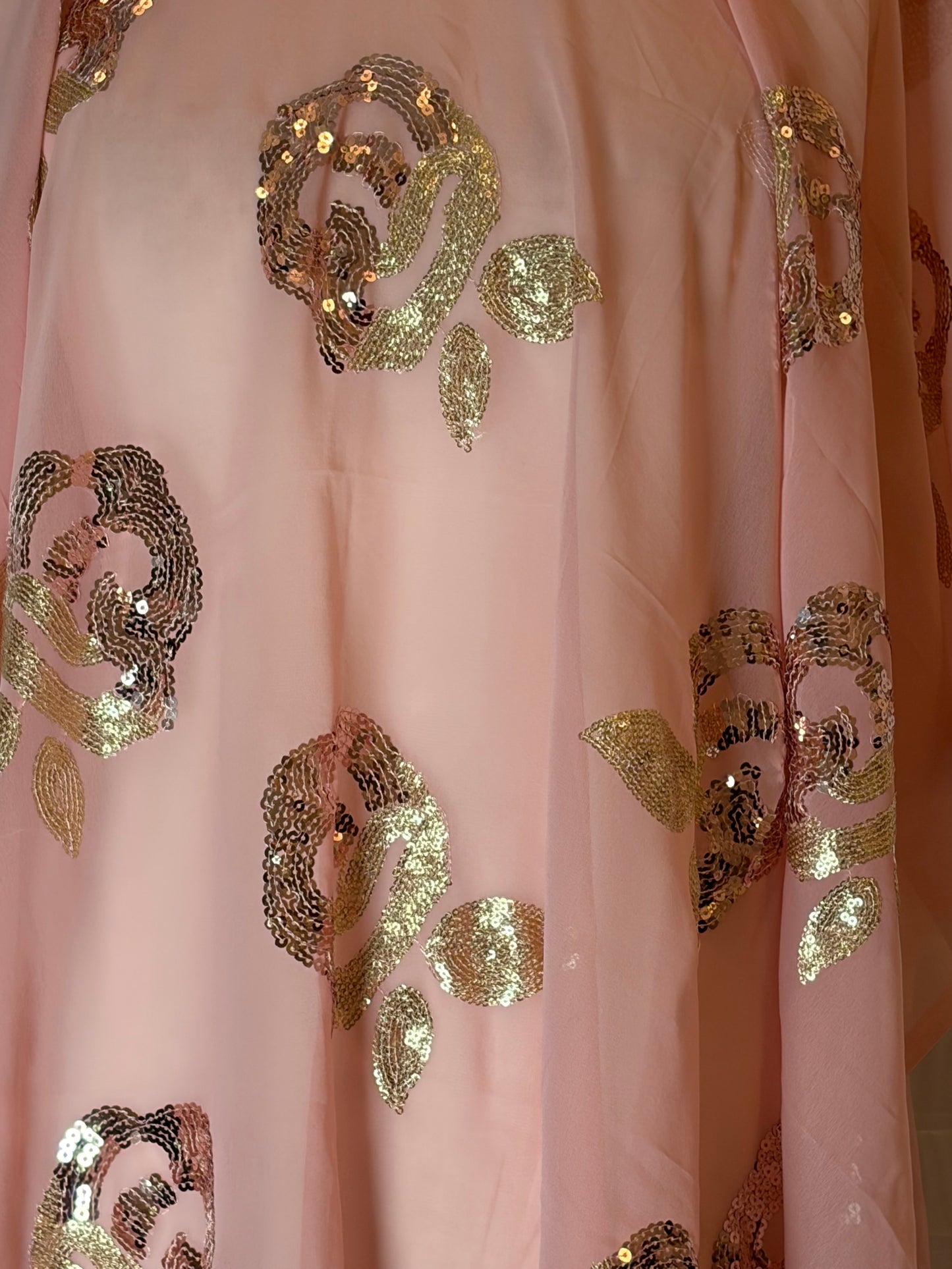 Pink fabric with gold sequin patterns