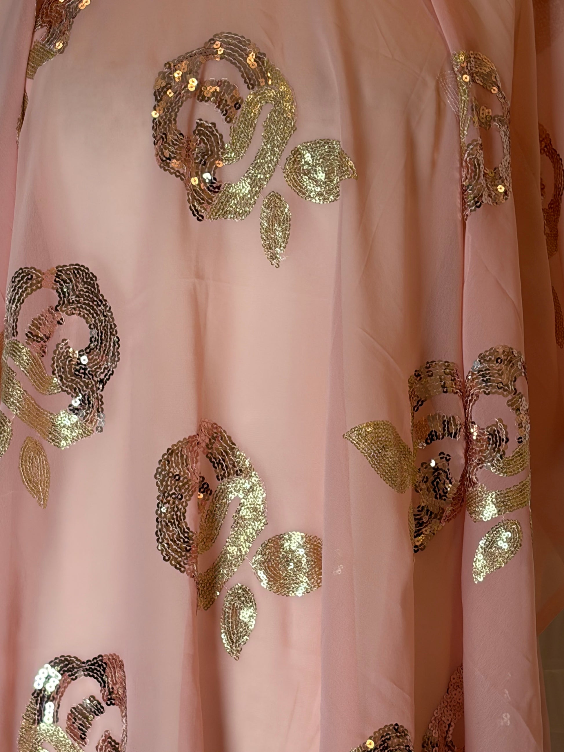Pink fabric with gold sequin patterns