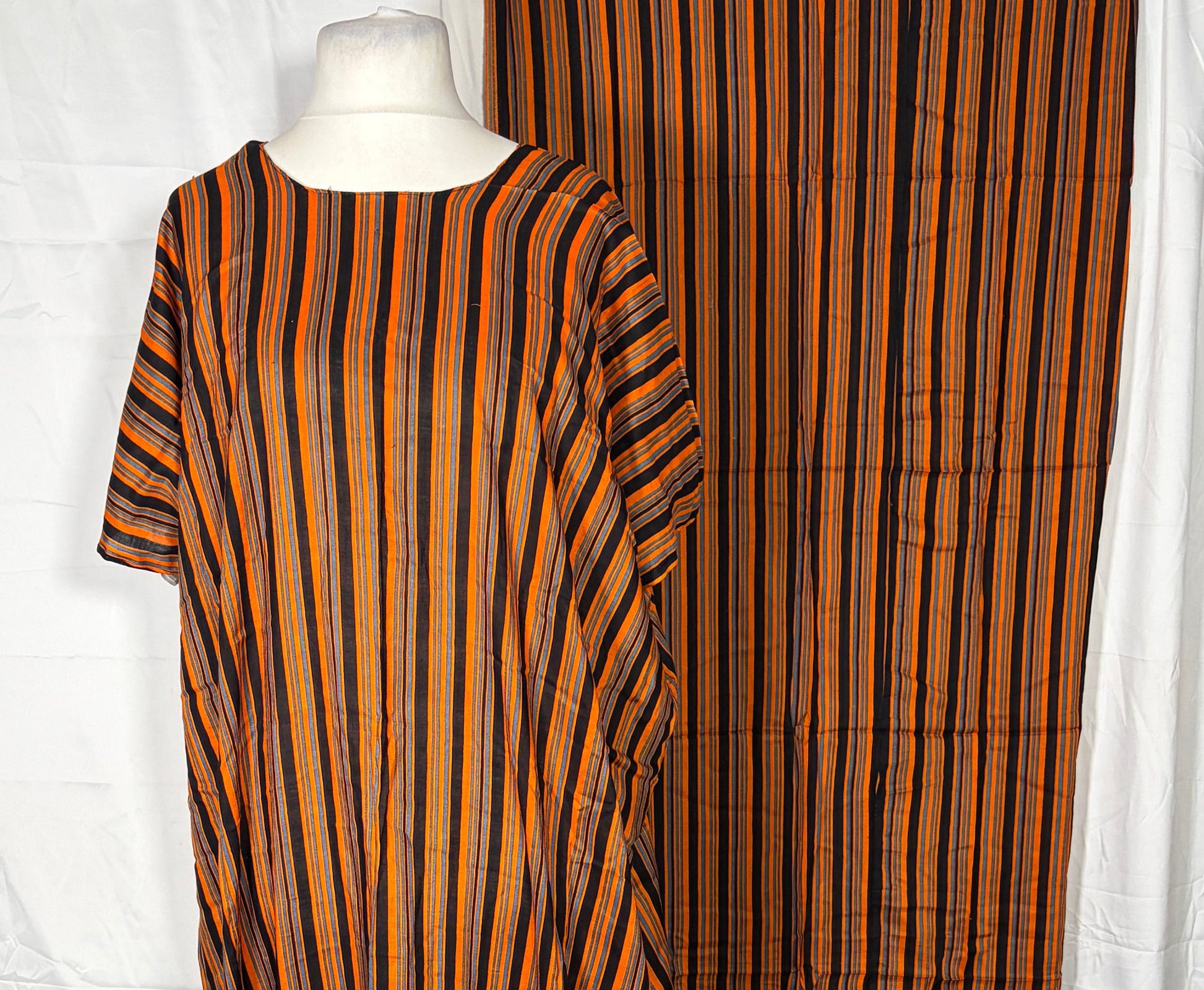 Brown striped fabric on a white surface with a wooden floor in the background