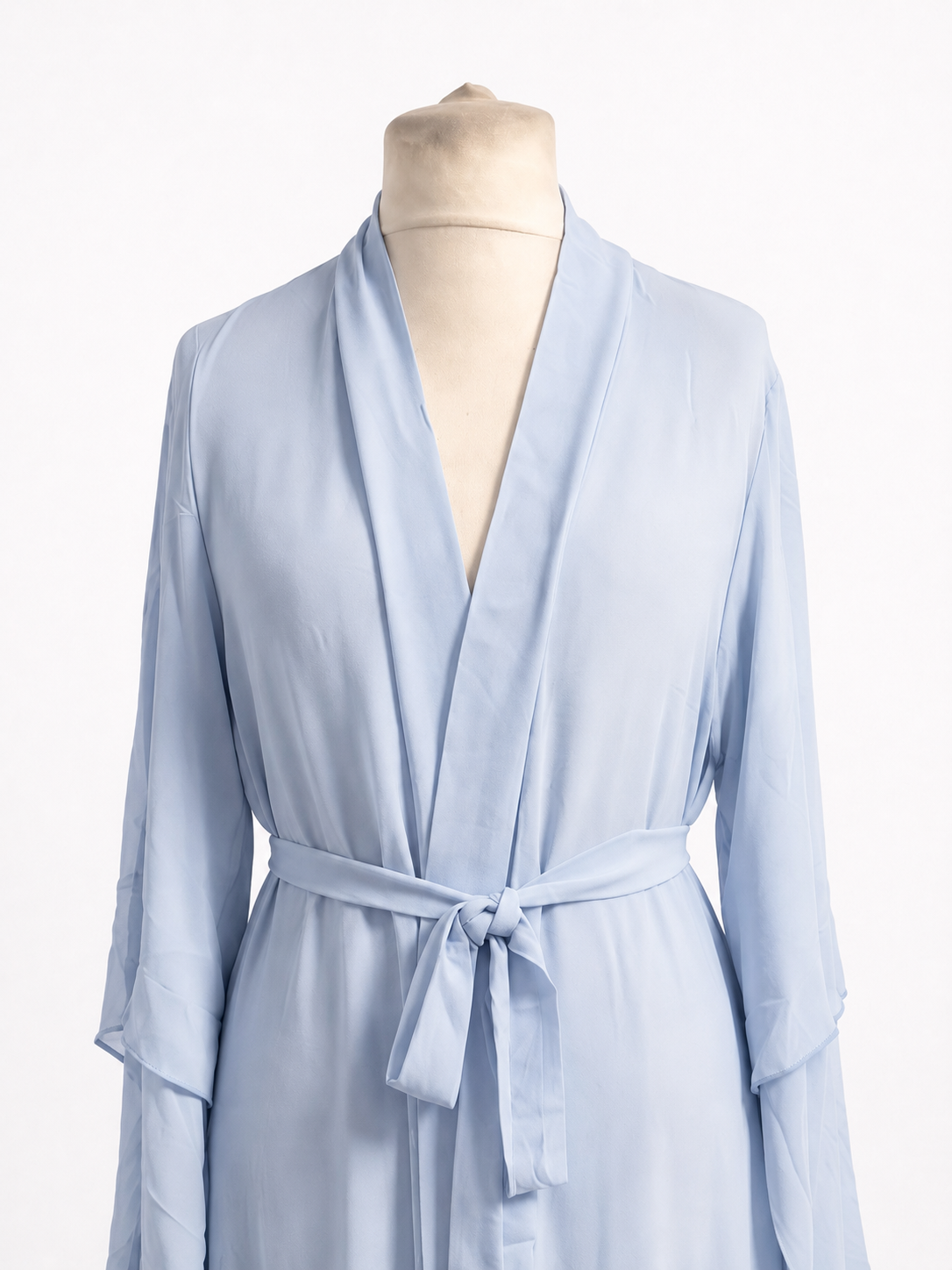 Light blue abaya on a mannequin against a white background