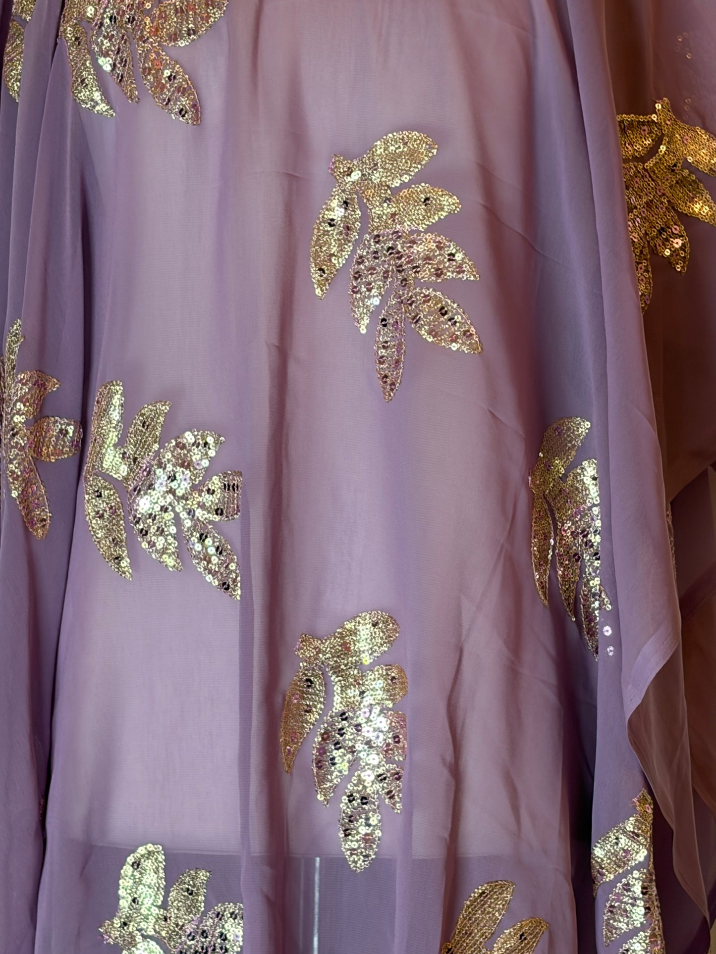 Close-up of purple Garbasaar fabric with gold leaf patterns