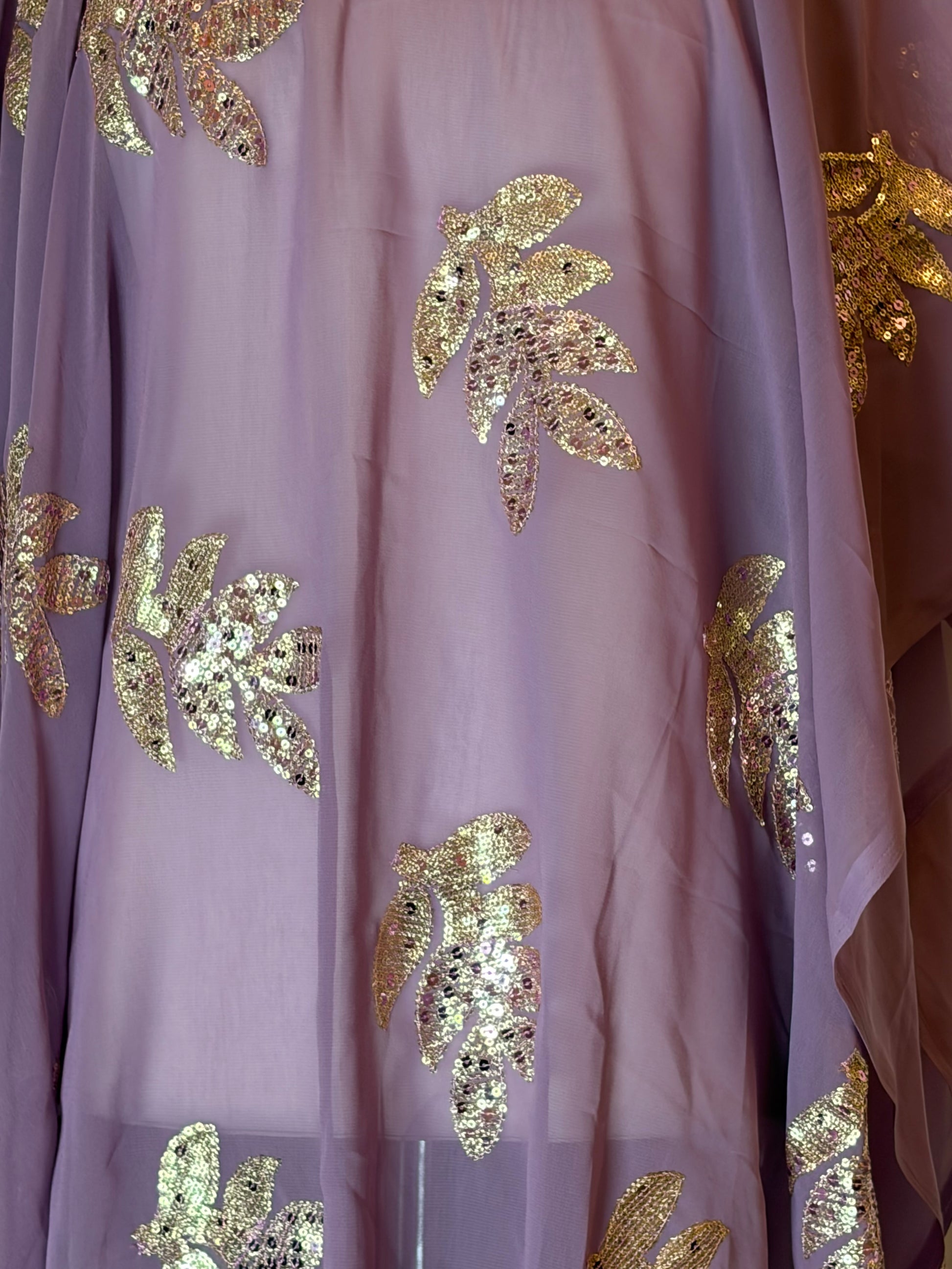 Close-up of purple Garbasaar fabric with gold leaf patterns