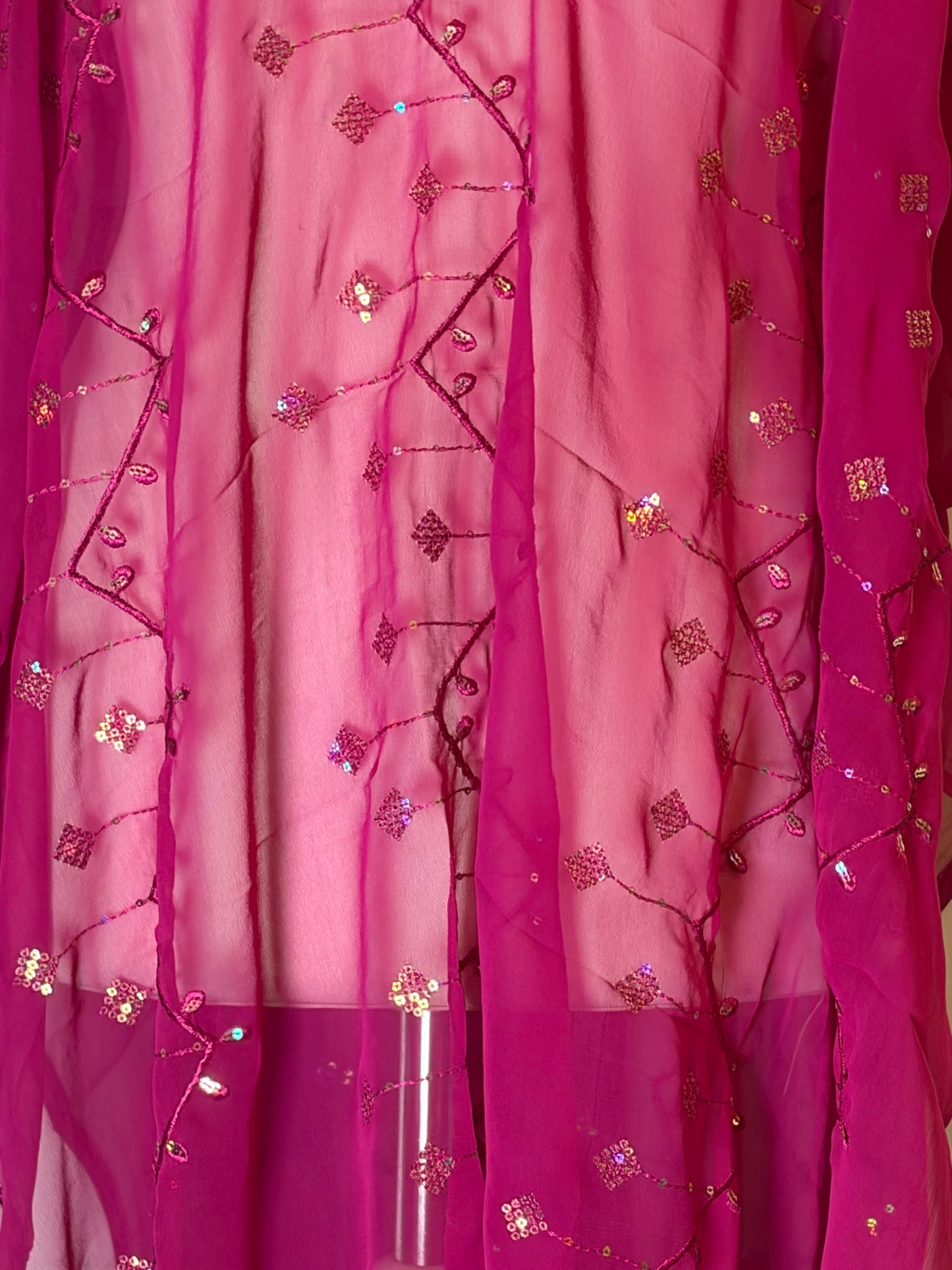 Pink Garbasaar fabric with decorative patterns and embellishments