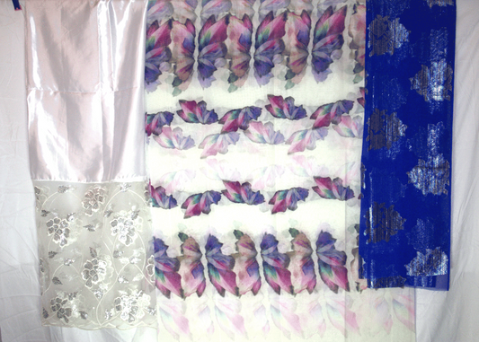 Butterfly patterned fabric with white, blue, and floral designs on a white background