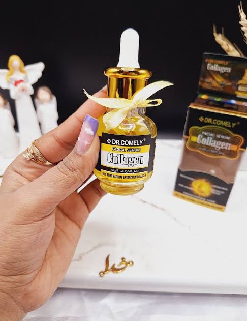 Dr. Comely Collagen serum bottle held by a hand with a blurred background