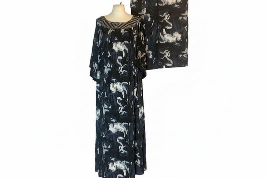 Black floral patterned dress on a mannequin against a white background