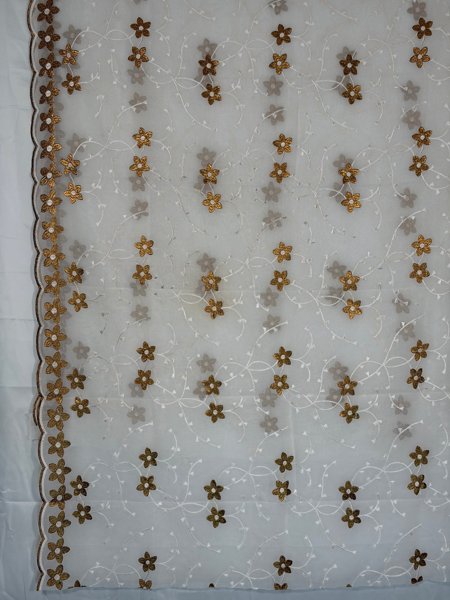 Embroidered fabric with floral patterns on a white background