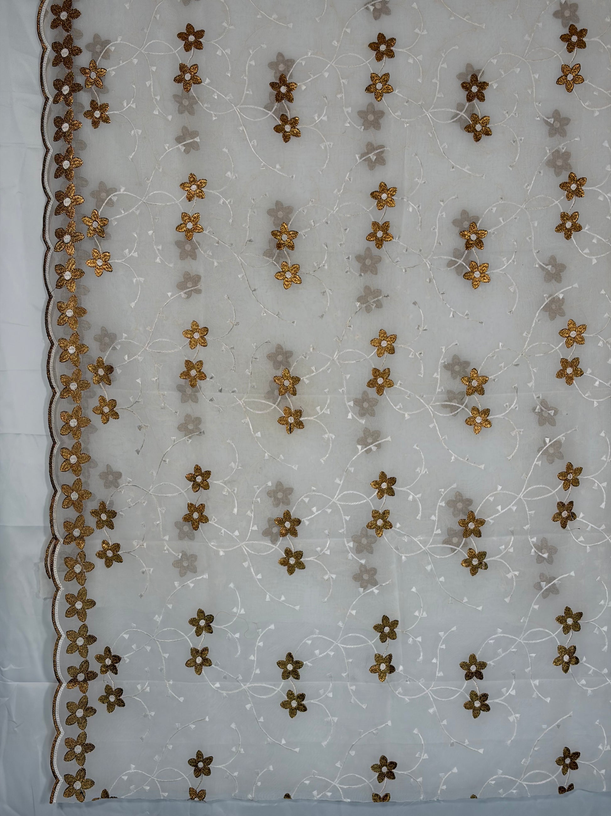 Embroidered fabric with floral patterns on a white background