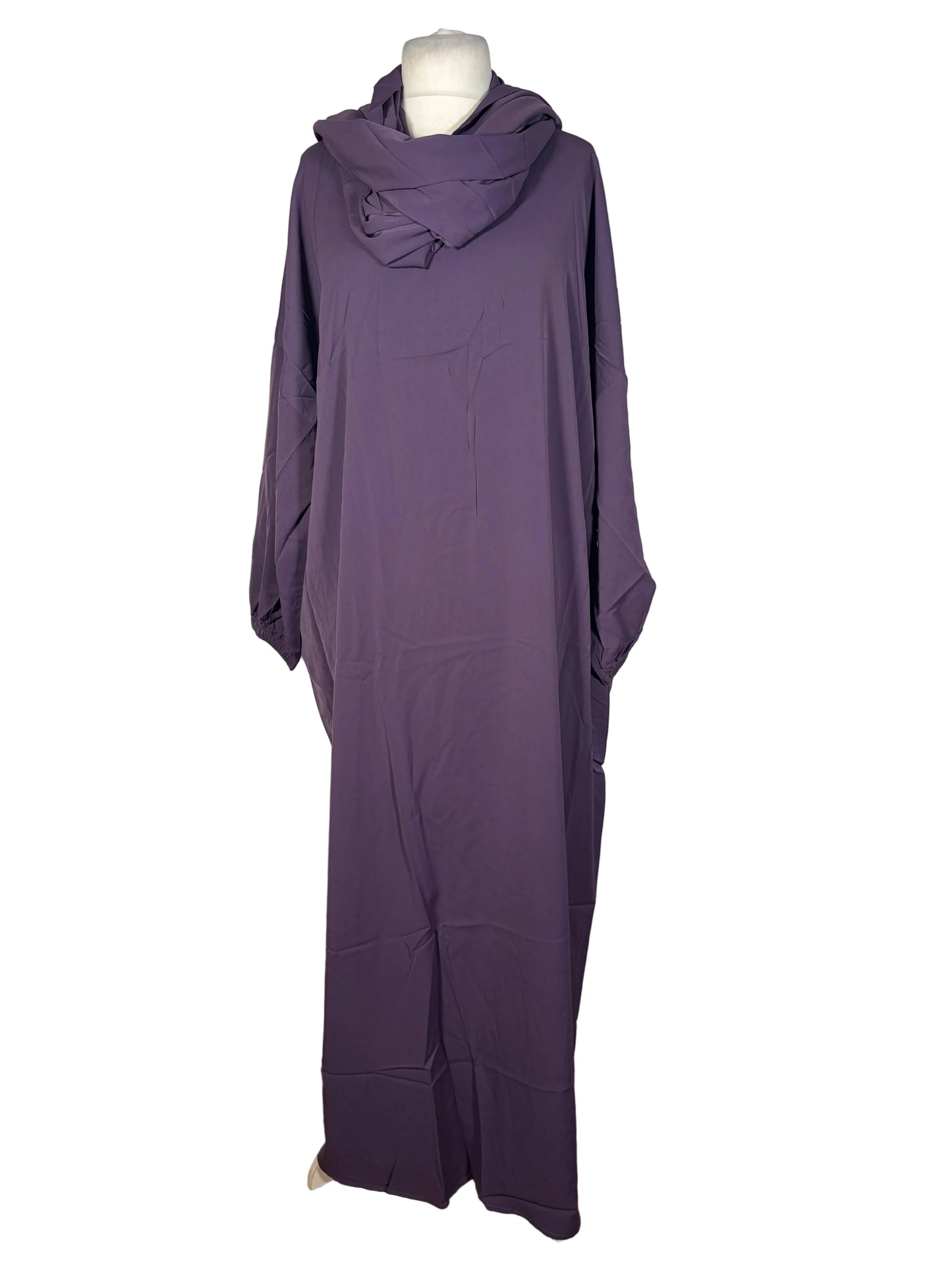 Purple Abaya dress on a mannequin against a white curtain background