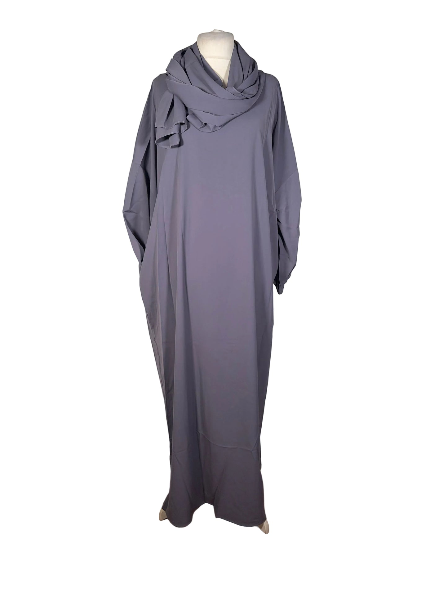 Gray dress on a mannequin against a white backdrop with wooden floor.