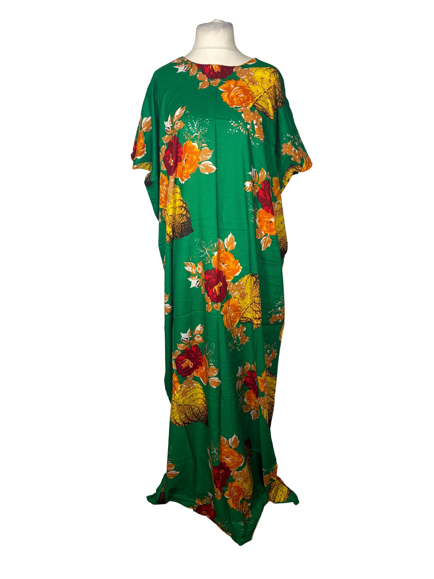 Green Somali Baati with colorful floral pattern on a mannequin against a white curtain background