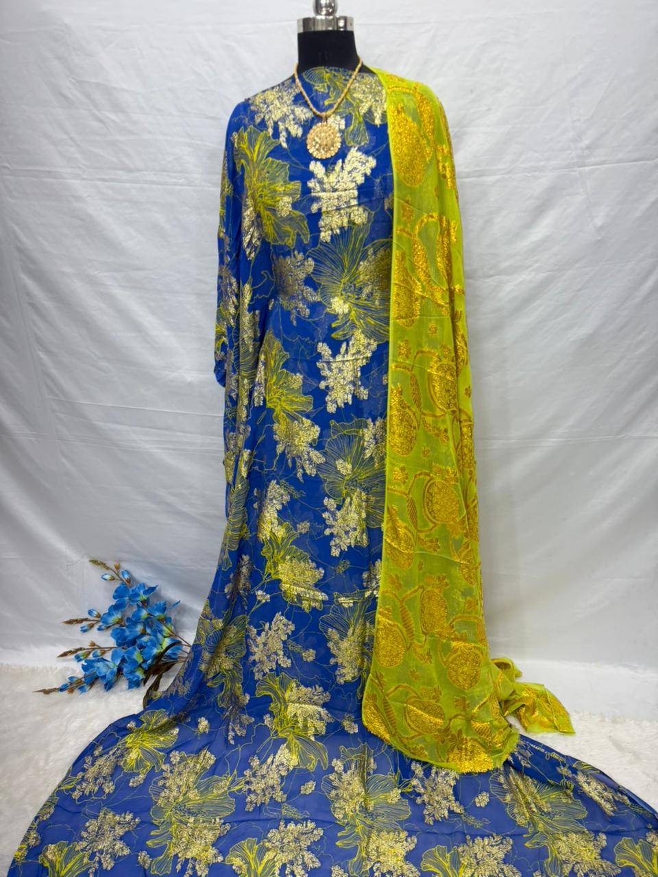 Blue and yellow floral patterned Somali dirac fabric on a mannequin against a white background