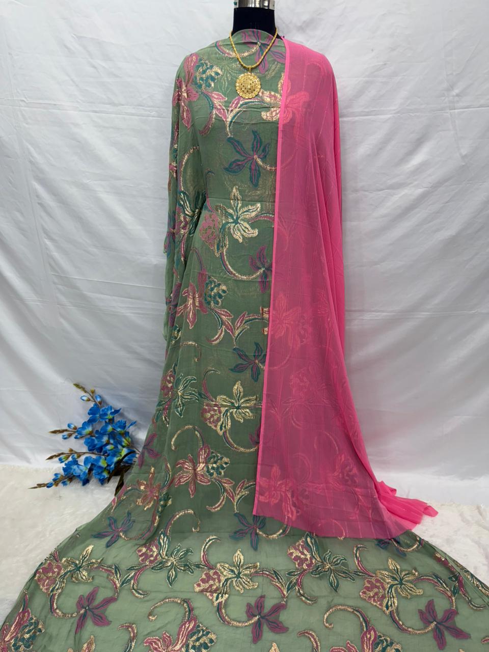 Green embroidered Somali Dirac Fabric with pink border on a white background
