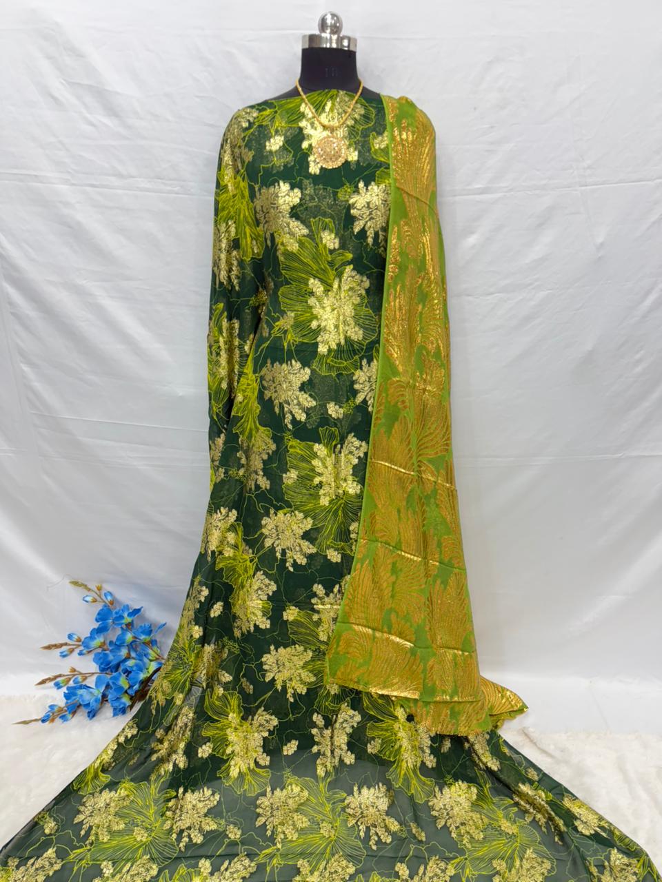 Green floral embroidered Somali dirac fabric with a yellow dupatta on a white background