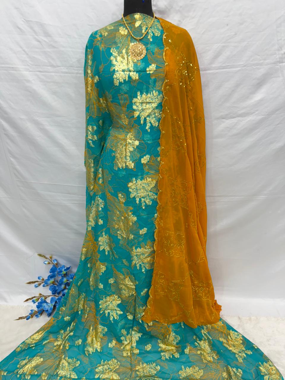Teal and mustard embroidered Somali dirac fabric with gold patterns on a white background