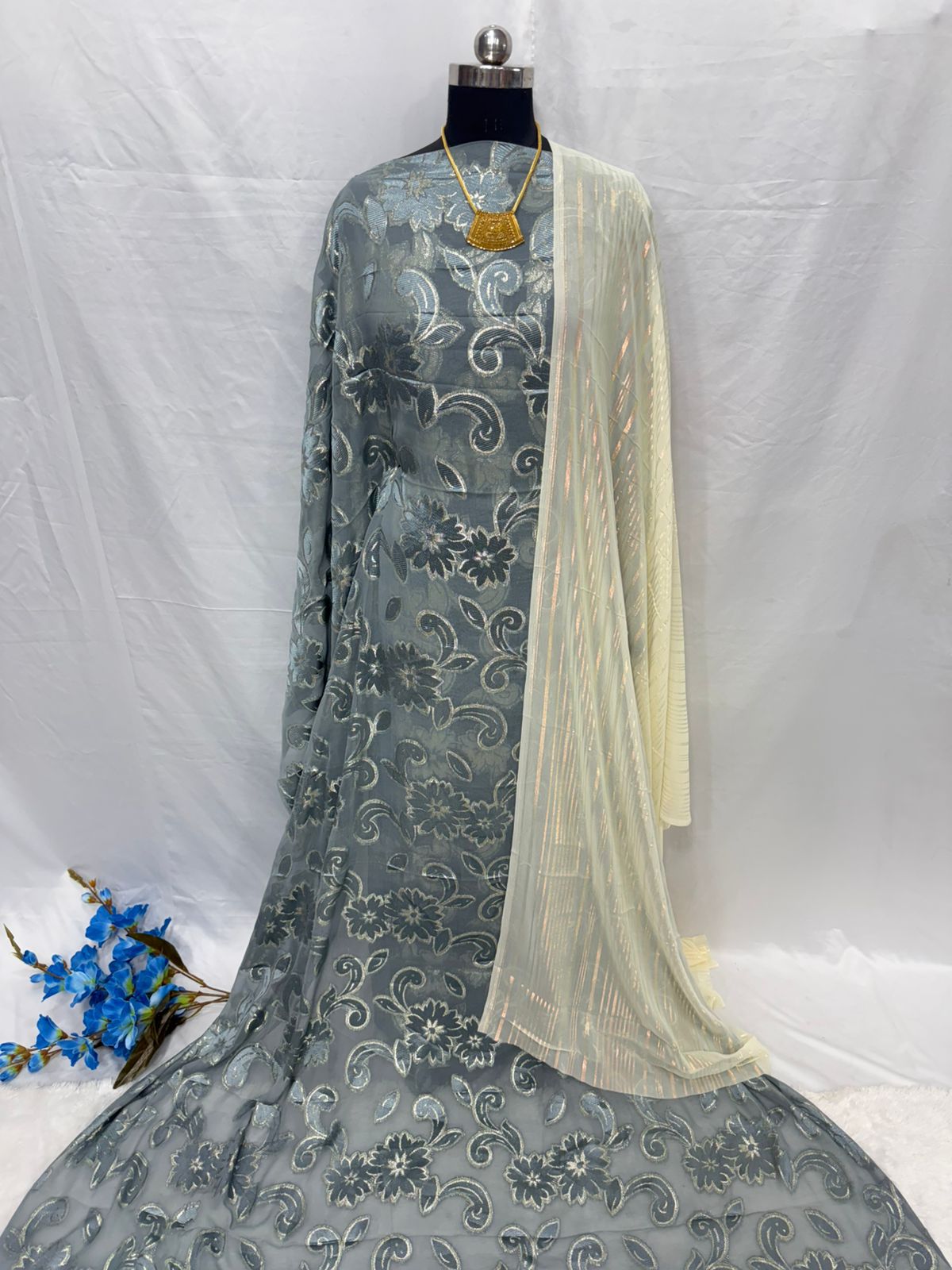 Gray embroidered Dirac Fabric with a yellow dupatta on a white background