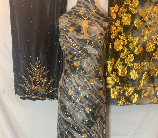 Three pieces  Dirac fabric with gold embroidery on a white background