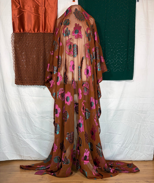 Brown fabric with pink floral pattern draped over a white surface