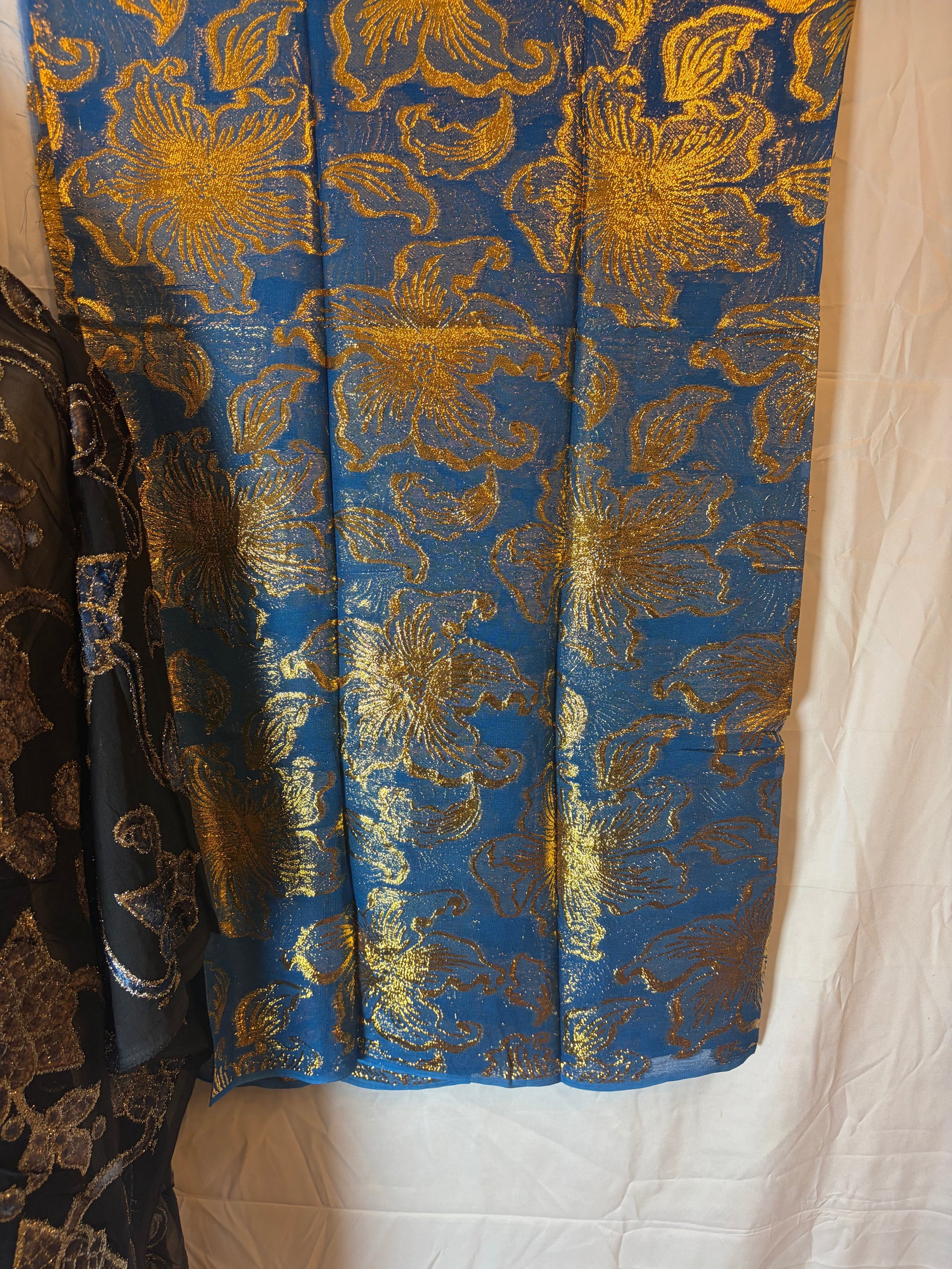 Garbasaaar Blue fabric with gold floral pattern on a white background