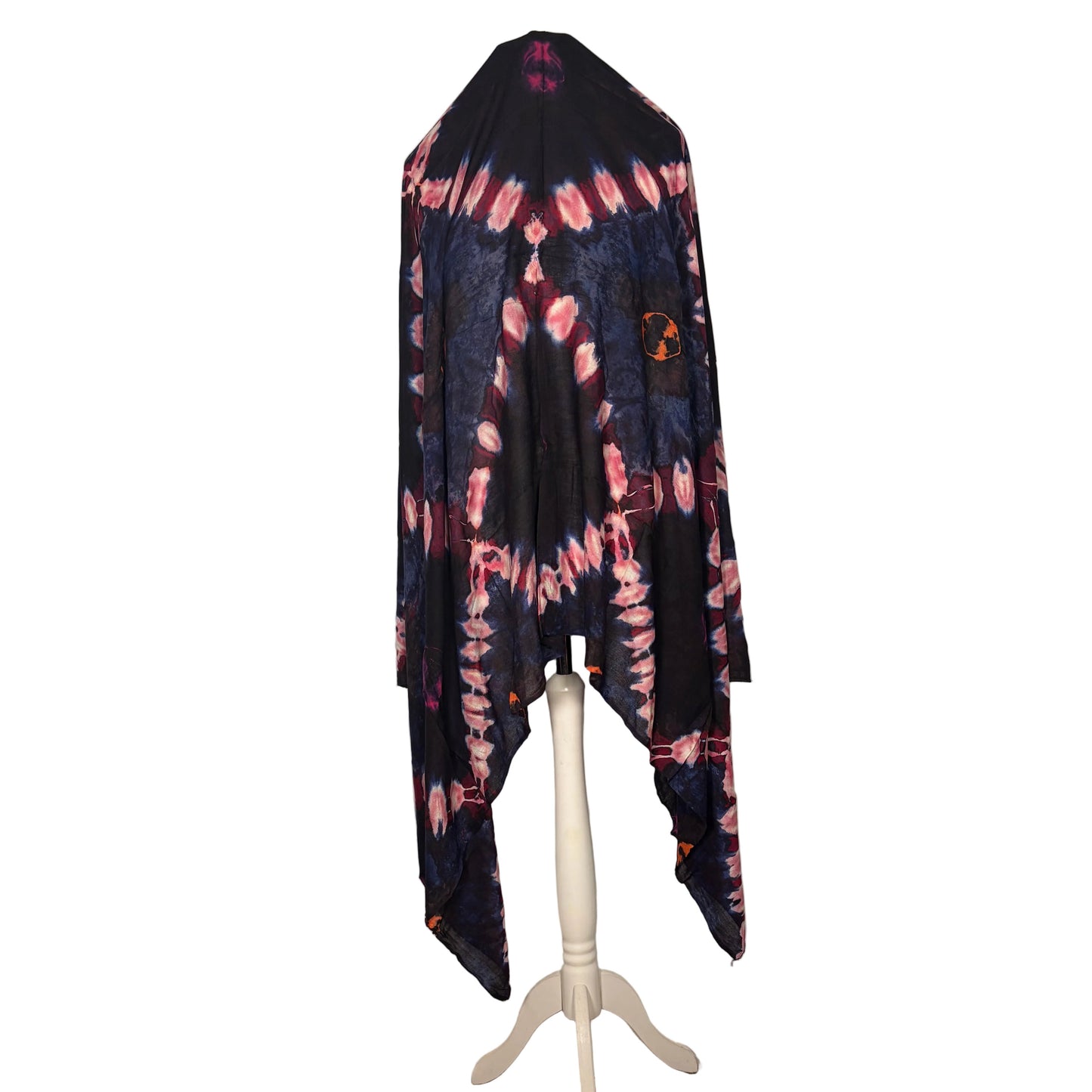 Tie-dye shirt hanging on a stand against a white backdrop