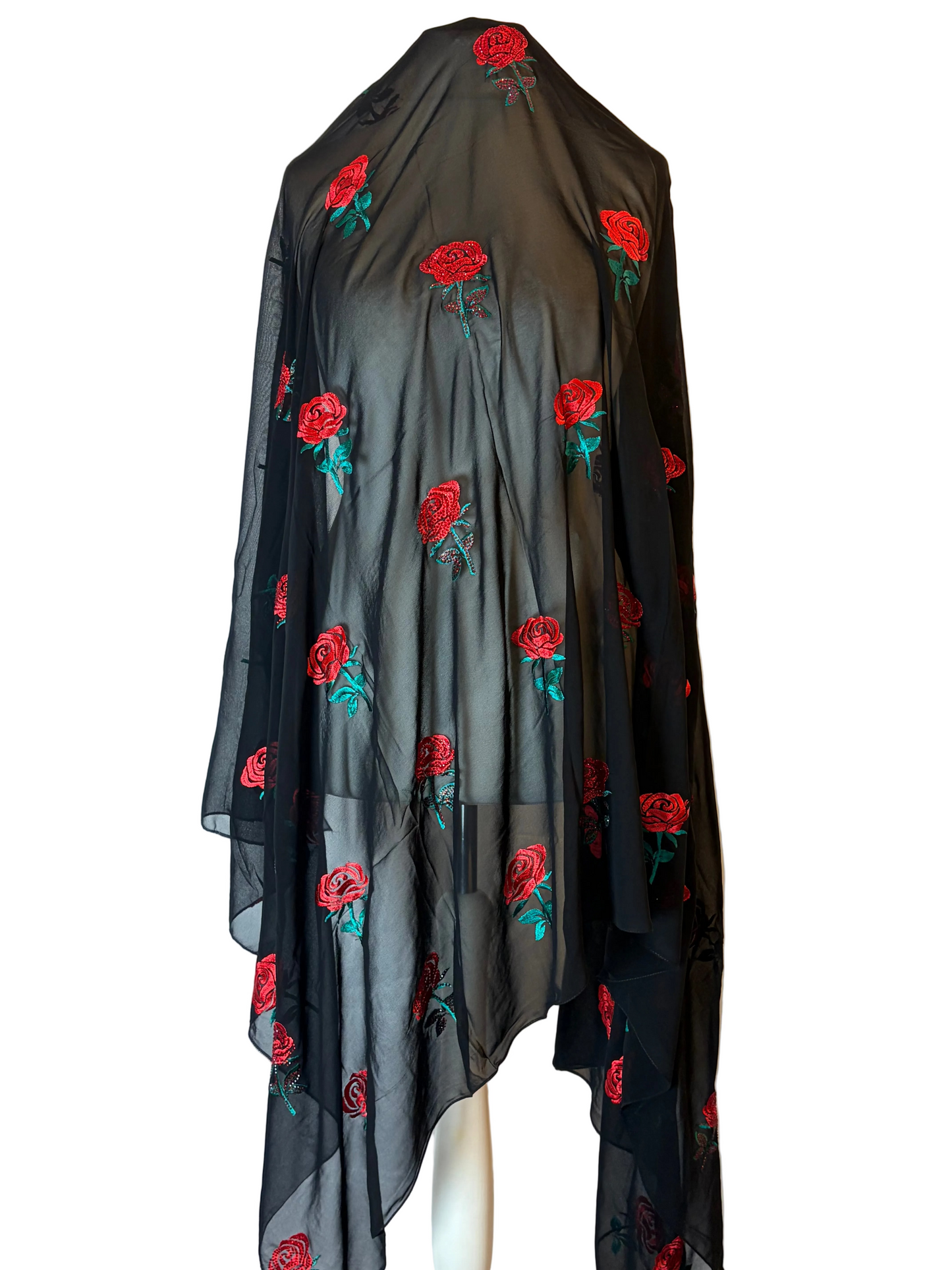 Black sheer garment with red rose embroidery on a white background