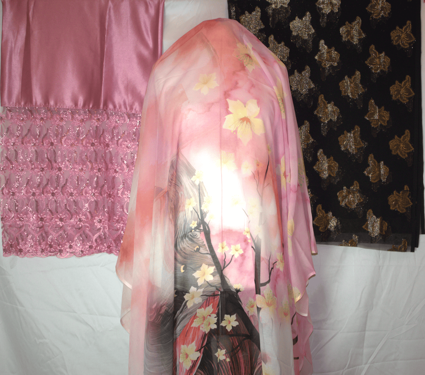 Pink floral German dirac draped over a mannequin with a pink and black patterned 