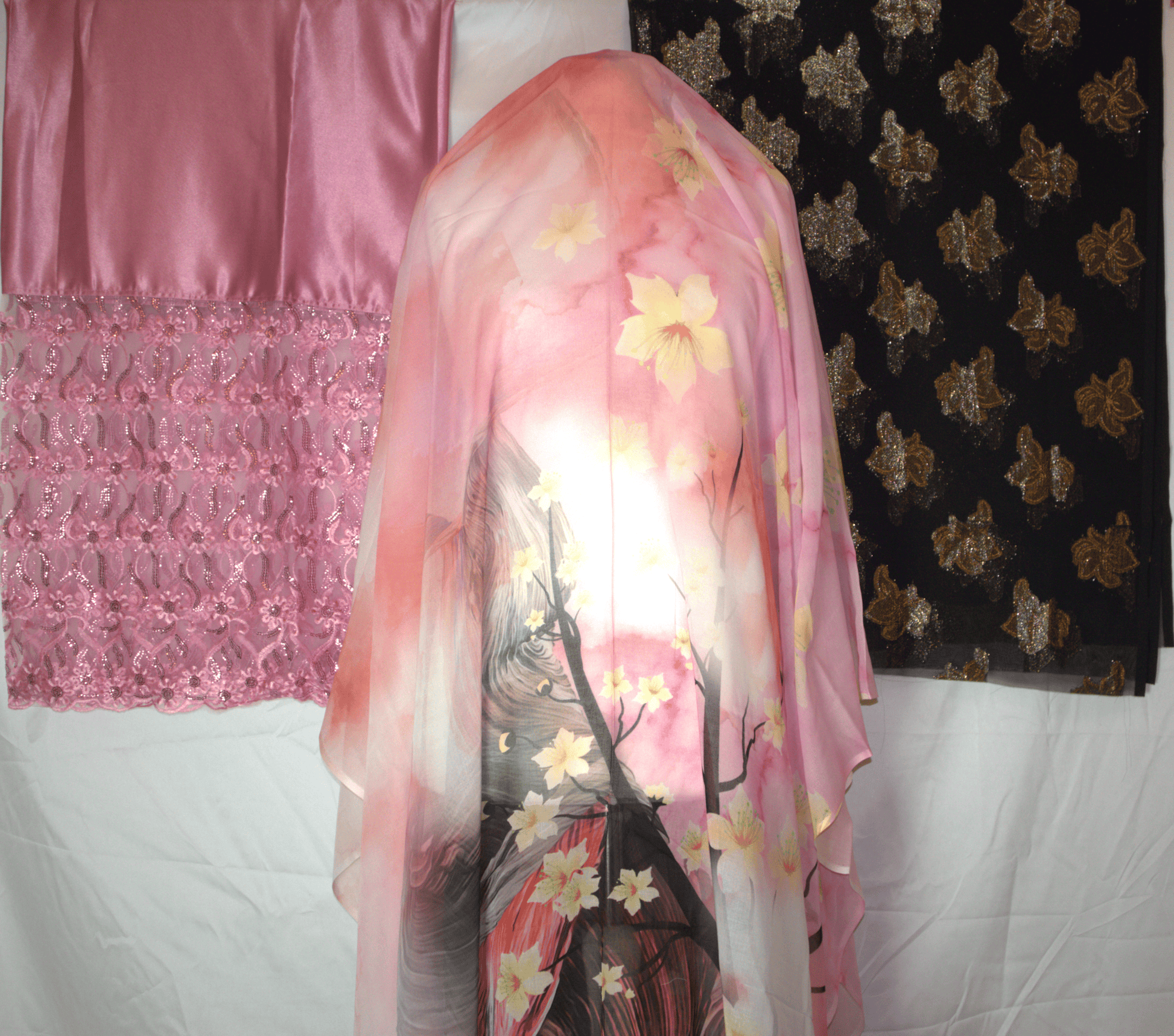 Pink floral German dirac draped over a mannequin with a pink and black patterned 