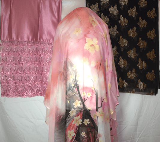 Pink floral German dirac draped over a mannequin with a pink and black patterned 