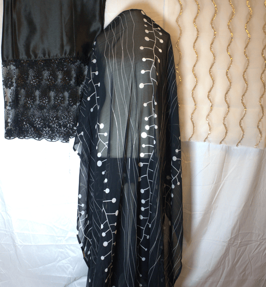 Black Somali Dirac with white patterns on a mannequin with White & gold gabsaar 
