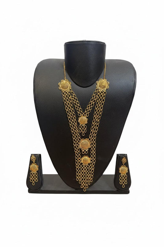 Gold-toned traditional Indian jewelry set featuring a multi-strand chain necklace, matching earrings, and a black display stand on a white background.